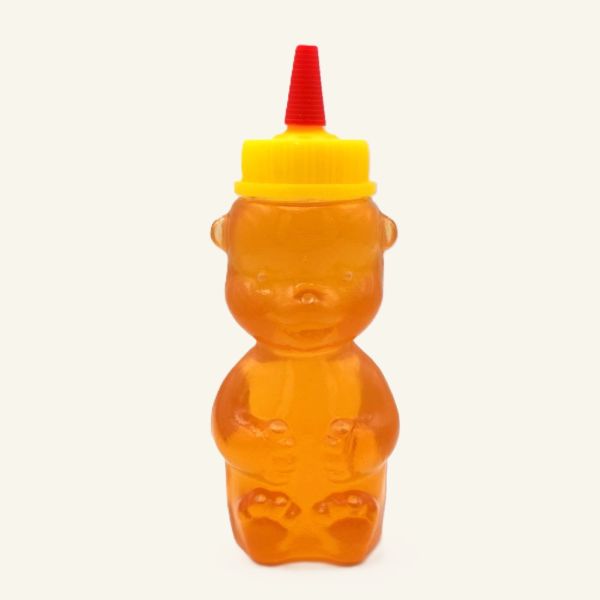 Honigbär Quetschflasche mit Bio-Sommerblütenhonig, gelber Deckel und roter Dosierspitze